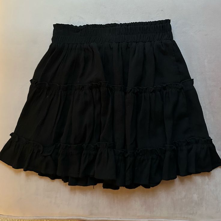 Black Skirt Never Worn. Mini. Ruffles. Super Cute. Size Small Chic Black Skort With Elastic Waistband, Black Skirt With Elastic Waistband For Summer, Black Pleated Skirt For Day Out, Black Relaxed Mini Skirt For Summer, High Waist Black Skirt With Elastic Waistband, Black Flowy Bottoms For Day Out, Black Flowy Mini Skirt For Day Out, Black Tiered Skort For Summer, Black Tiered Skirt For Night Out