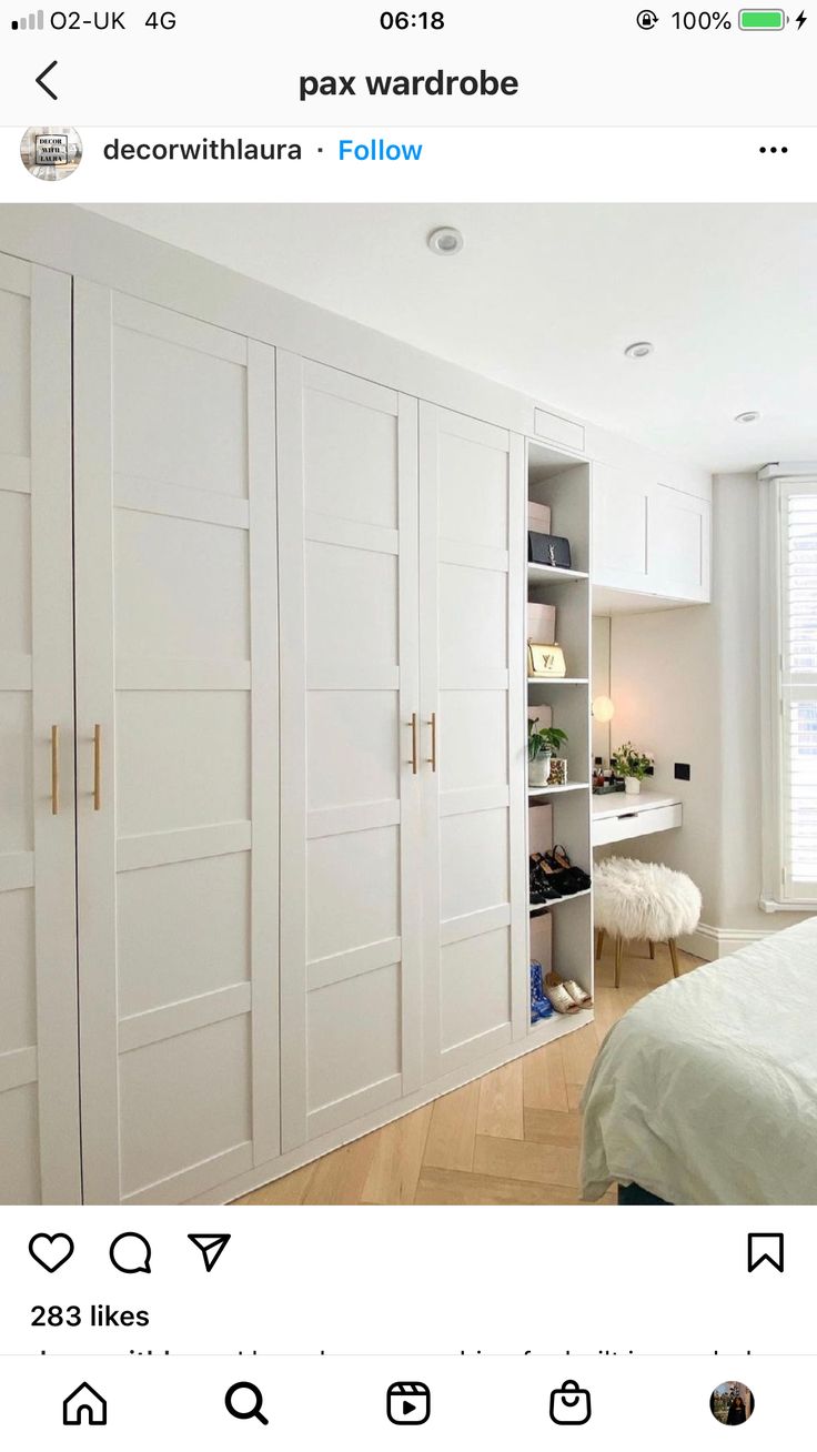 an image of a bedroom with white closets on the left and right hand side