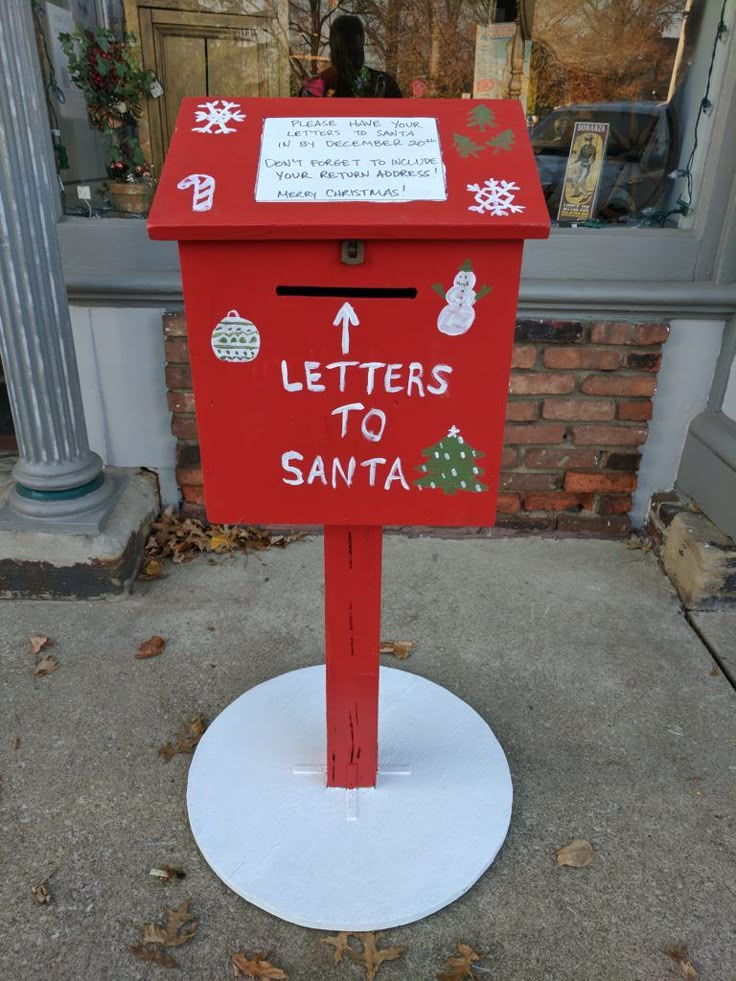 a red mailbox with letters to santa written on it