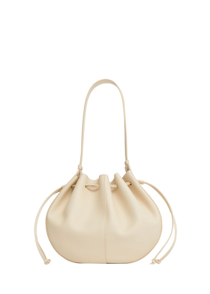 "Find MANSUR GAVRIEL Flores Drawstring Leather Shoulder Bag on Editorialist. Mansur Gavriel \"Flores\" shoulder bag in calf leather Shoulder strap, 10.2\" drop Drawstring closure Approx. 9.8\"H x 7.8\"W x 3.5\"D Spot clean Made in Italy" Luxury Smooth Grain Saddle Shoulder Bag, Mansur Gavriel Candy Bag, Mansur Gavriel Cloud Clutch, Mansur Gavriel Bag Lady, Mansur Gavriel, Leather Shoulder Bag, Calf Leather, Shoulder Strap, In Italy