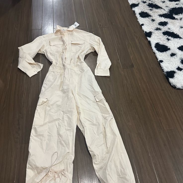 Zara Cargo Cream Long Sleeve Jumpsuit White Long Sleeve Jumpsuit With Pockets, Utility Long Sleeve Jumpsuits And Rompers For Spring, Spring Utility Long Sleeve Jumpsuits And Rompers, Spring Utility Jumpsuits And Rompers With Long Sleeves, Spring Long Sleeve Utility Jumpsuits And Rompers, Cream Cotton Jumpsuits And Rompers With Pockets, Cream Long Sleeve Jumpsuits And Rompers For Spring, Cream Fitted Long Sleeve Jumpsuits And Rompers, Cream Long Sleeve Jumpsuits For Spring