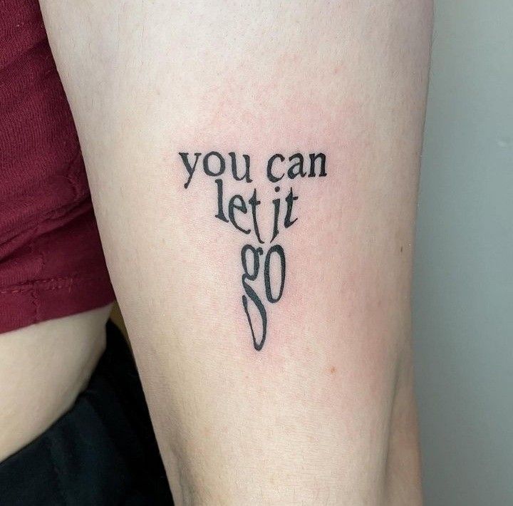 a woman with a tattoo saying you can let it go on her arm and leg