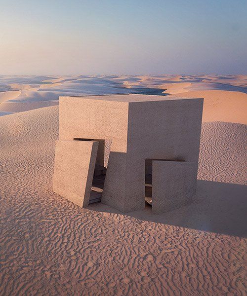 a concrete structure sitting on top of a sandy beach next to the ocean and sand dunes