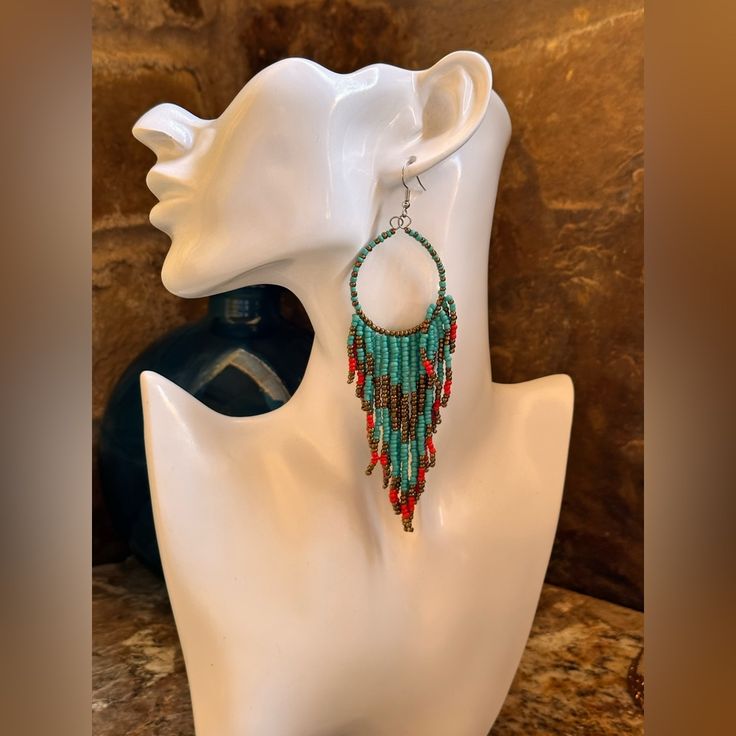 Turquoise Colored And Red Seed Bead Dangle Earrings . They Are In A Waterfall Design And Length Is 2.5 Inches And Light Weight . Turquoise Beaded Dangle Chandelier Earrings, Turquoise Beaded Earrings With Beaded Chain, Turquoise Dangling Beaded Earrings, Turquoise Beaded Chain Earrings, Turquoise Dangle Beaded Earrings, Adjustable Turquoise Chandelier Earrings With Dangling Beads, Turquoise Chandelier Earrings With Colorful Round Beads, Turquoise Earrings With Beaded Chain And Round Beads, Turquoise Earrings With Beaded Chain