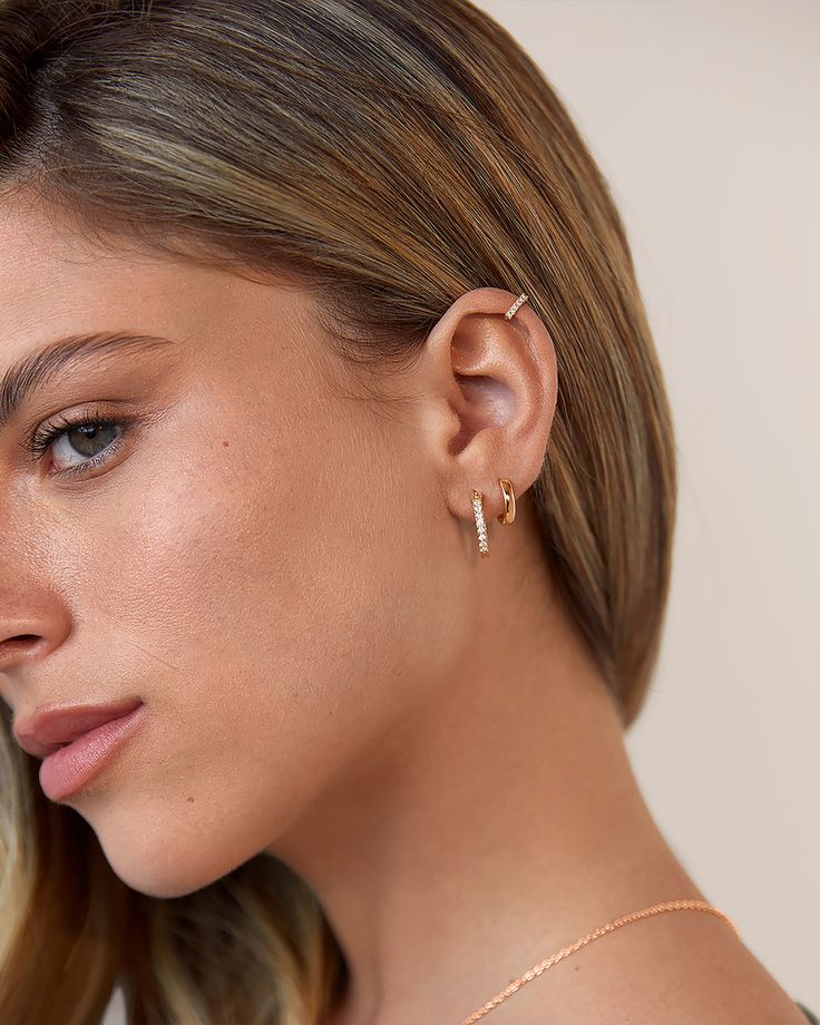 Streamlined and modern, PAVOI Mini CZ Huggies are dazzling and trace the classic shape of hoop earrings. Materials: 14K yellow, rose or white gold plated Measurements: 6mm Inner Diameter, 9mm Outer Diameter; Thickness: 1.5mm Classic Rose Gold Huggie Earrings For Pierced Ears, Classic Rose Gold Sterling Silver Huggie Earrings, Modern Rose Gold Pierced Huggie Earrings, Rose Gold Huggie Hoop Earrings Vvs Clarity, Classic Huggie Earrings With Cubic Zirconia, Classic Cubic Zirconia Huggie Earrings For Pierced Ears, Everyday Rose Gold Hoop Earrings With Prong Setting, Rose Gold Cubic Zirconia Small Hoop Huggie Earrings, Rose Gold Tarnish-resistant Huggie Earrings