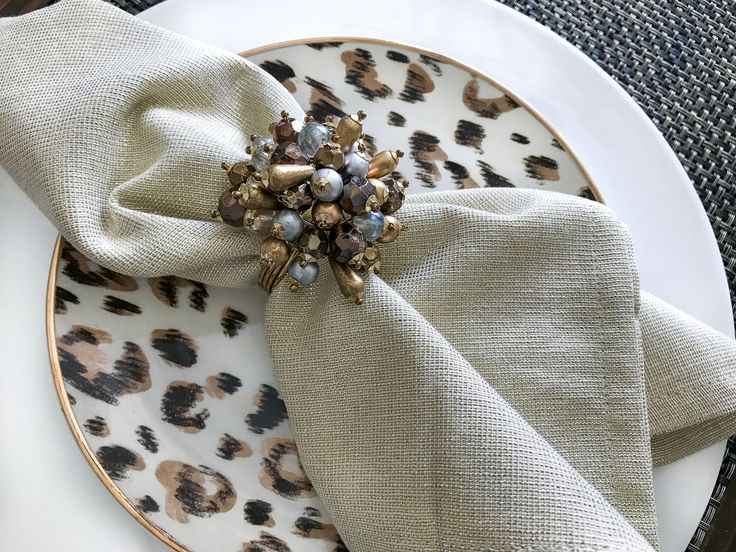 a white plate topped with an animal print napkin