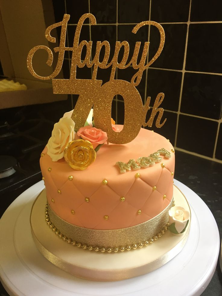 a pink and gold birthday cake sitting on top of a white plate with the number forty