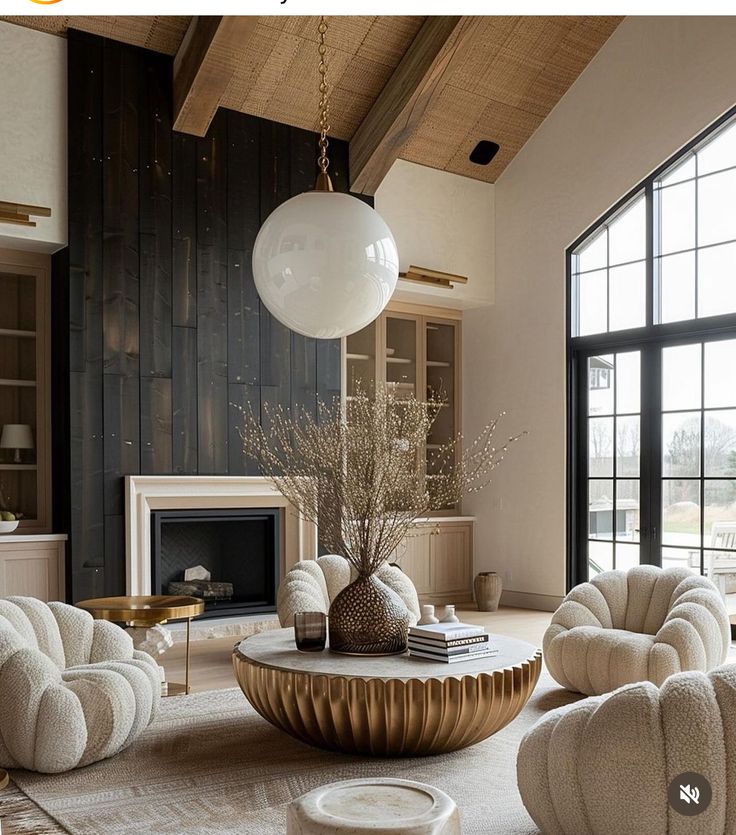 a living room filled with furniture and a fire place in front of a large window