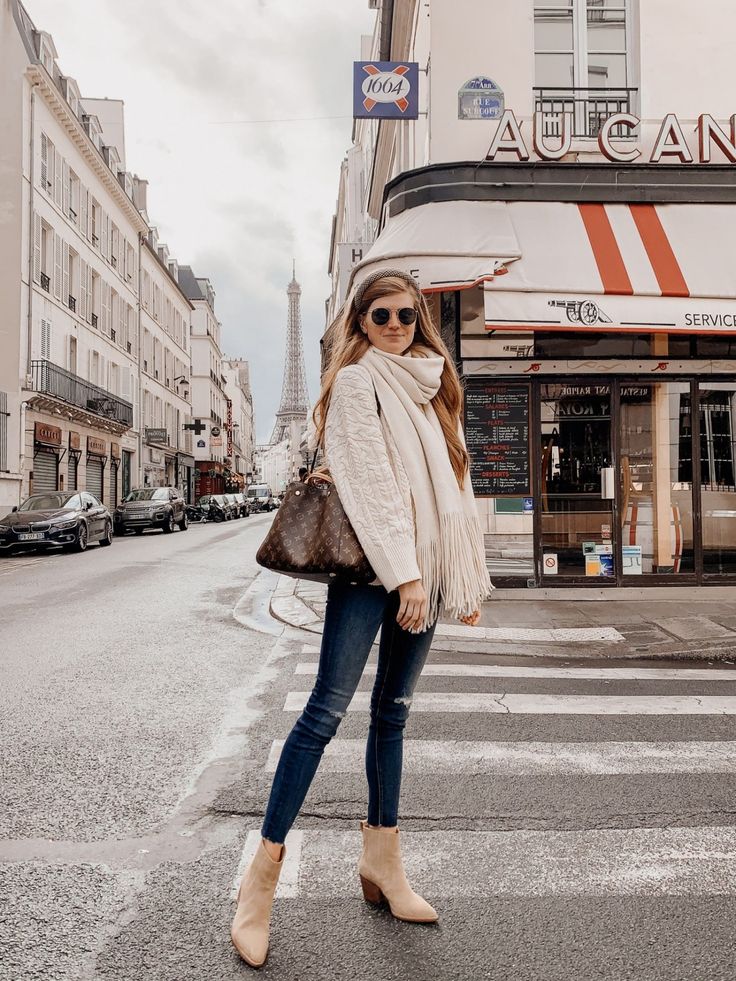 Lifestyle blogger shares what to wear in Paris in October | Lifestyle blogger shares what to wear in Paris in October | What to Pack for Paris in October by popular London travel blogger Mollie Moore: image of a woman standing outside in Paris and wearing a Zara CABLE-KNIT SWEATER, Free People FREE PEOPLE Whisper Fringe Blanket Scarf, Main, color, BLACK Whisper Fringe Blanket Scarf, Nordstrom Mother The Looker High Waist Frayed Ankle Skinny Jeans, J.Crew Western boots in tan suede, Asos River I Europe Fashion October, London Outfits For October, Paris Outfits For October, What To Wear In Paris In October 2023, Switzerland In October Outfits, What To Wear In Amsterdam In October, Outfits For Winter In Europe, Fall In Amsterdam Outfits, London Outfits November