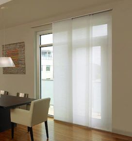 a dining room table and chairs with white curtains in front of the sliding glass doors