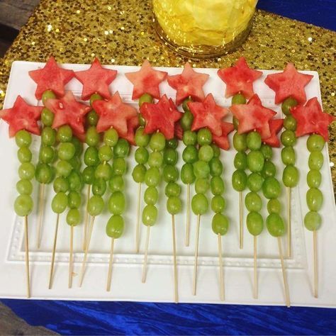 grapes and watermelon are arranged on skewers with stars