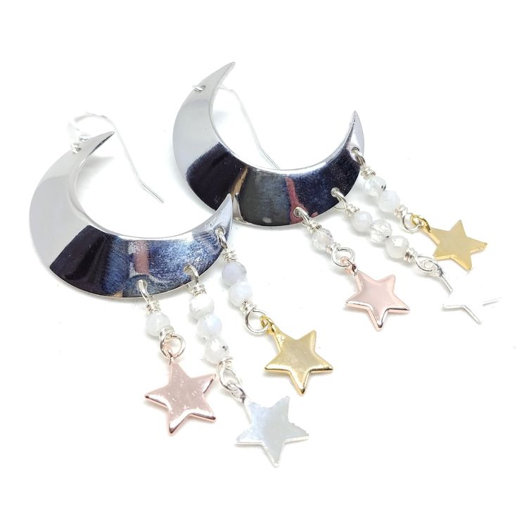 You were born with the imprint of the moon and stars on your soul. Show your ties to the ethereal night sky with these sparkling moon and star earrings! These earrings dangle 2 3/4". Sterling silver ear wires, rhodium plated moons, moonstones. To keep these moon and stars bright and shiny, I recommend a Sunshine Polishing Cloth! Adjustable Silver Celestial Hoop Earrings, Celestial White Sterling Silver Earrings, White Sterling Silver Celestial Earrings, Celestial Silver Dangle Hoop Earrings, Silver Moon Shaped Jewelry With Ear Wire, Nickel-free Moonstone Moon Earrings, Nickel-free Moonstone Moon-shaped Earrings, Silver Mystical Jewelry With Ear Wire, Mystical Silver Jewelry With Ear Wire