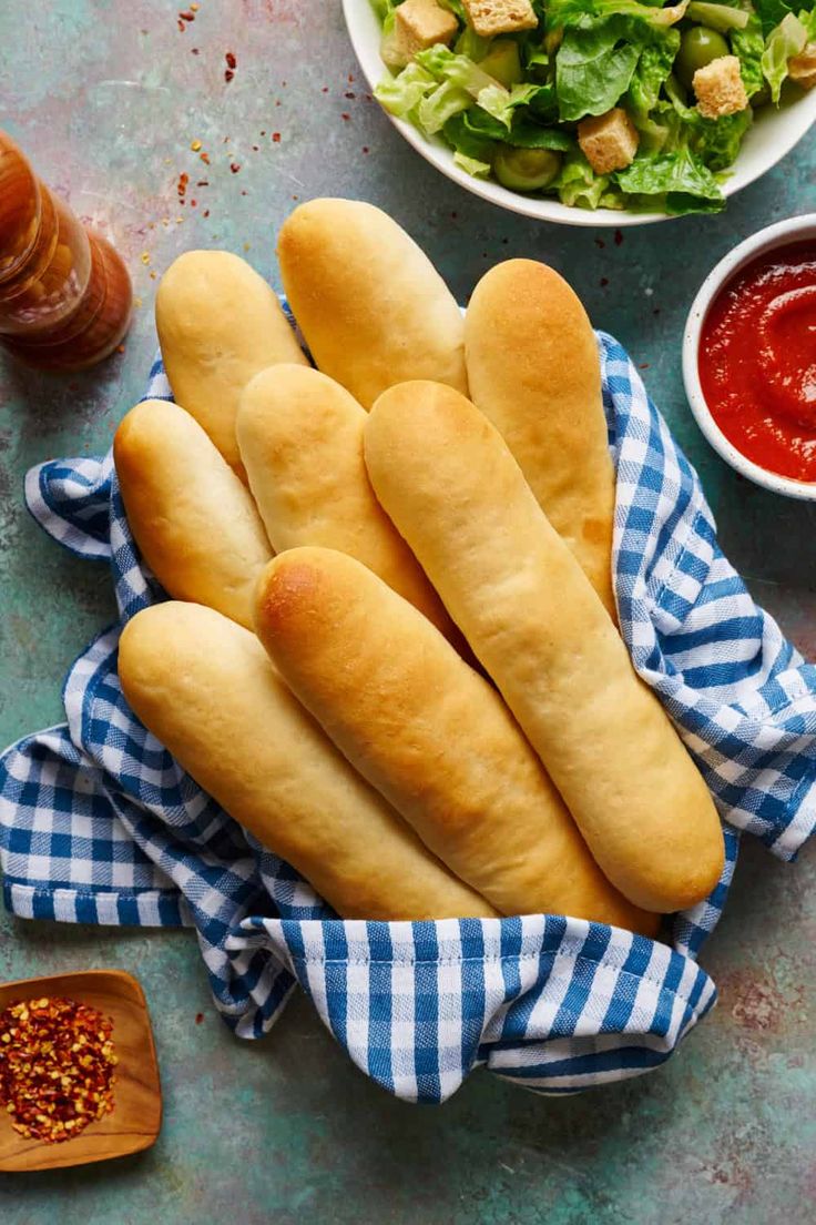 Breadsticks in a napkin with marinara and salad on the side Discard Pasta Noodles, Discard Garlic Bread Quick, French Bread Sourdough Discard, Sourdough Breadsticks Discard, Sourdough Breadsticks Quick, Sourdough Discard Breadsticks Recipe, Sourdough Discard Baguette, Sourdough Discard Bread Sticks, Sourdough Discard Pasta