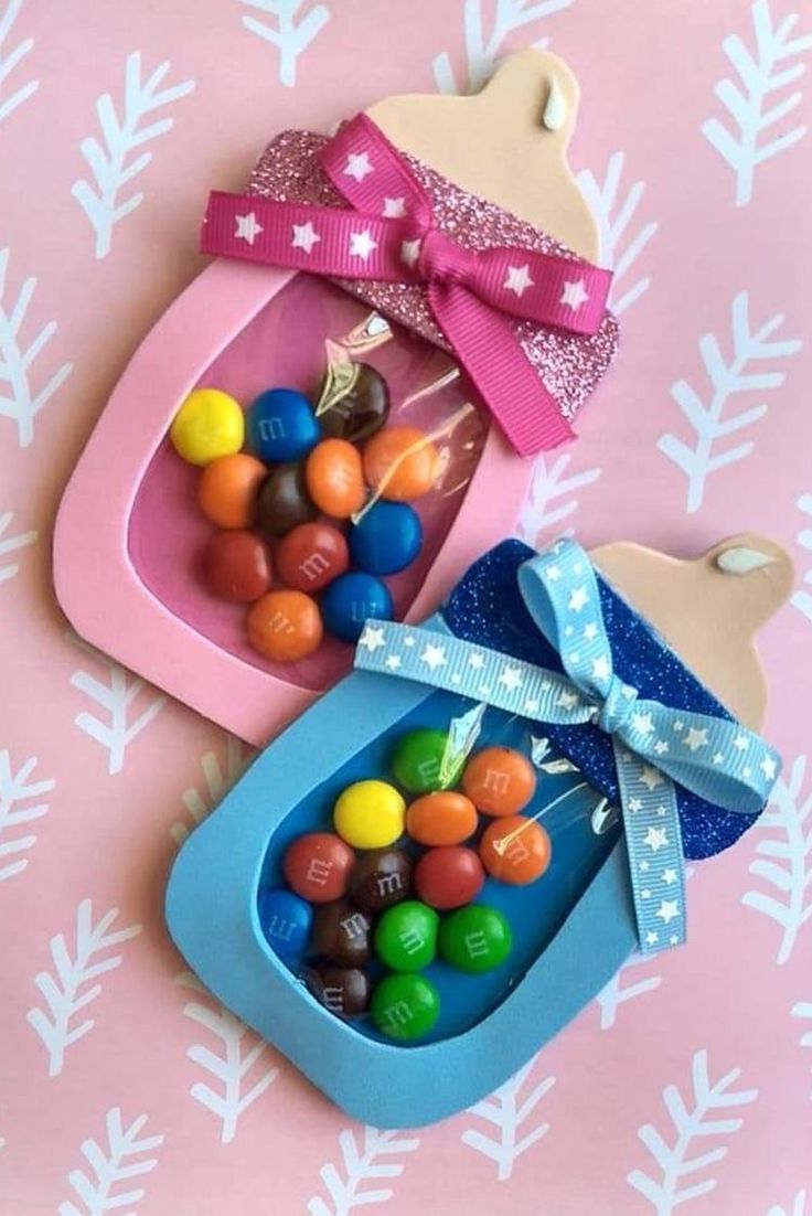 two plastic containers filled with candy on top of a table