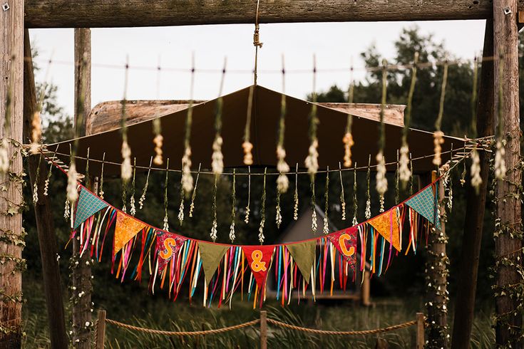 there is a string with tassels hanging from it in front of a wooden structure