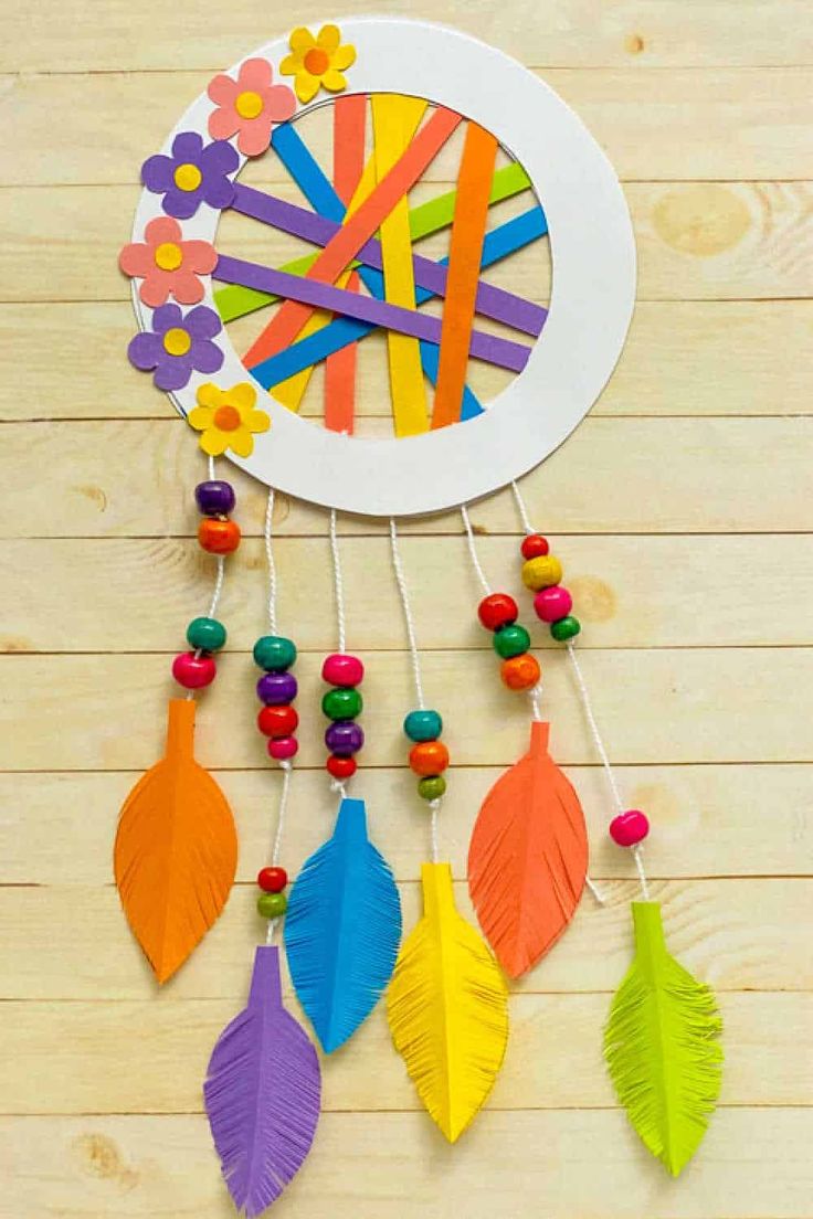 an easy paper plate dream catcher with colorful feathers and beads