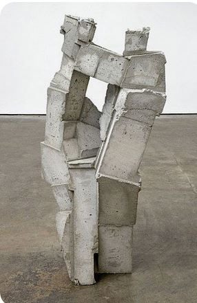 a sculpture made out of concrete blocks in an empty space with no one around it