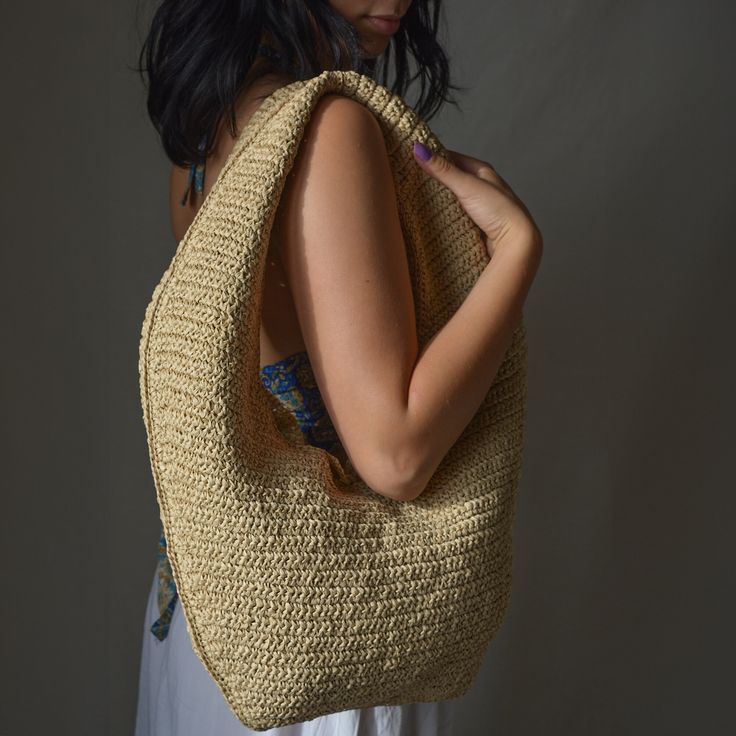 Looking for a stylish yet practical accessory? This Crochet Raffia Hobo Bag is a perfect choice. Handmade with natural color raffia straw, this shoulder bag blends both function and fashion. Whether you're heading to the beach or navigating your daily routine, this minimalist hobo bag is designed to elevate your style while staying practical. Crafted with care over 15-16 hours, this bohemian piece showcases the unique texture of natural raffia, known for its eco-friendly and lightweight properti Crochet Hobo Bag, Raffia Crochet, Product Story, Bohemian Minimalist, Summer Tote Bags, Vacation Days, Beach Gifts, Raffia Bag, Crochet Woman