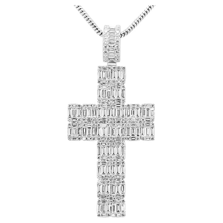 Make a bold statement of faith and elegance with our fashion statement cross pendant. This piece is crafted in 14K white gold, offering a timeless and luxurious backdrop for the dazzling array of diamonds that adorn it. The pendant features 2.59 carats of baguette diamonds, carefully set by our master artisans by hand to create a sleek and modern aesthetic. The clean lines and geometric precision of the baguette cut diamonds add a contemporary flair, reflecting light with every movement and crea Statement Of Faith, Round Diamond Pendant, Diamond Baguette, Gold Hamsa, Reflecting Light, Hamsa Pendant, Baguette Diamonds, Chain Fashion, Modern Necklaces