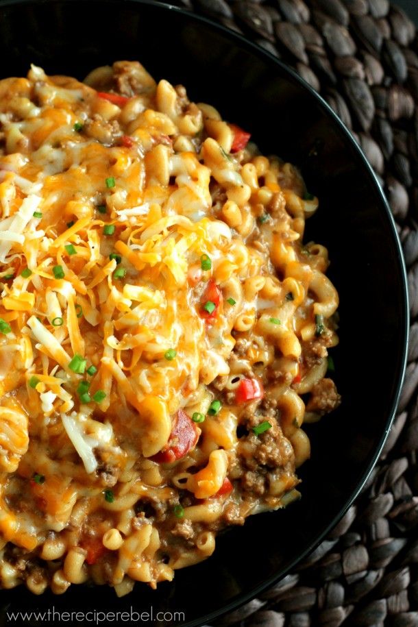 a black bowl filled with macaroni and cheese