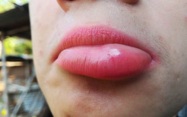 a woman with pink lipstick on her lips