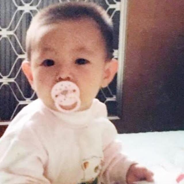 a baby with a pacifier in it's mouth