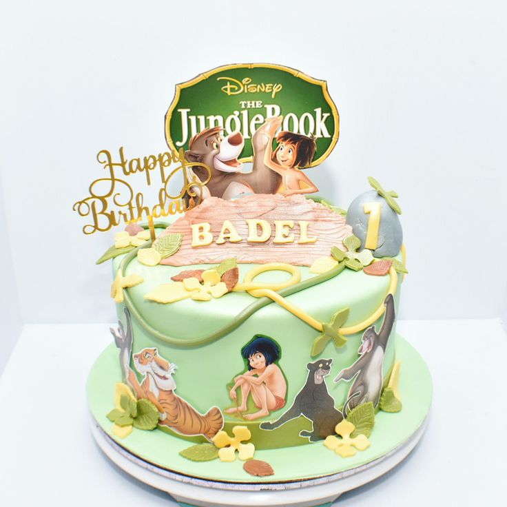 a birthday cake with an image of the jungle book on it's frosting