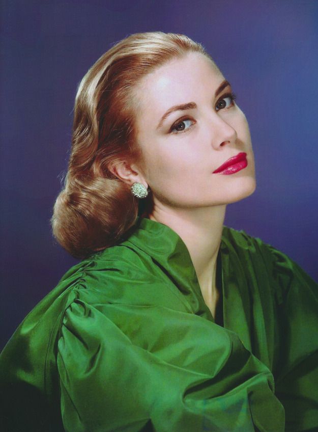 a woman in a green dress posing for a photo