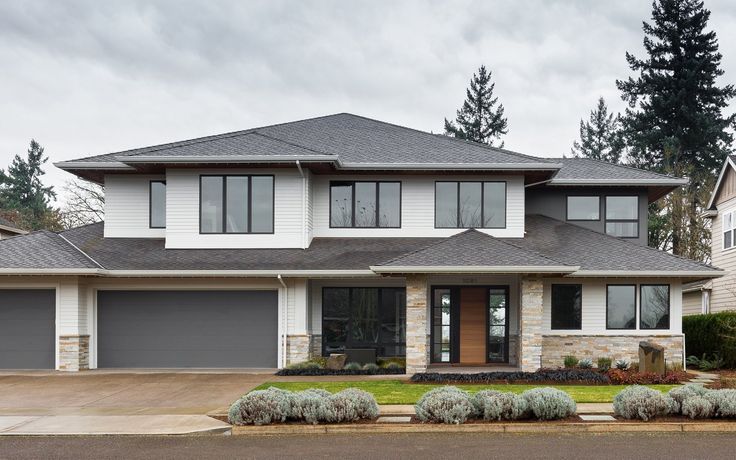 a large house with lots of windows and landscaping