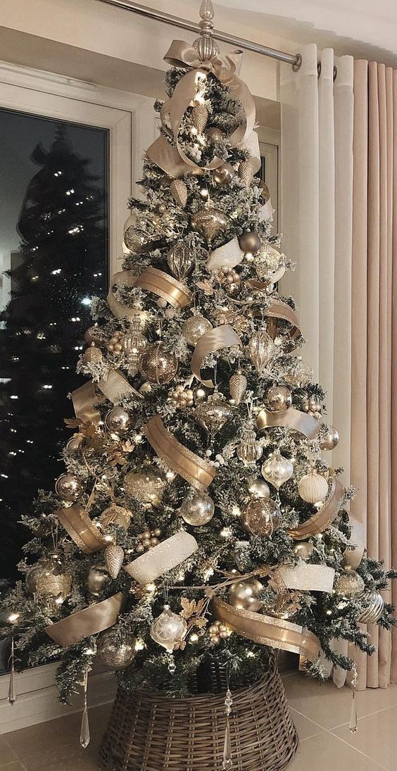 a christmas tree decorated with gold and silver ornaments