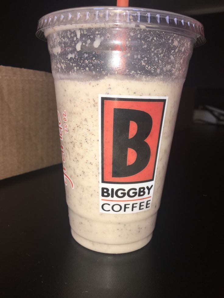 a biggby coffee cup sitting on top of a table