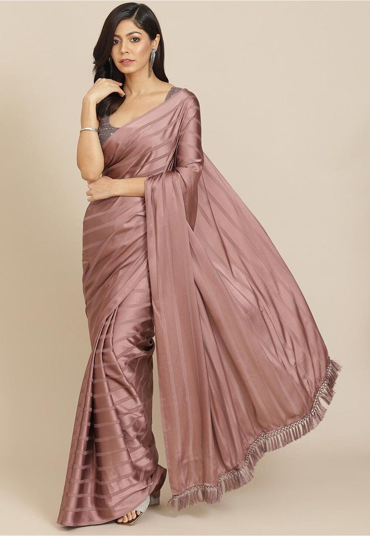 Satin Saree in Old Rose This attire is Enhanced with Resham, Shimmer, Sequins and Tassels Work Available with an Unstitched Lycra Blouse in Brown and Black Do note: Blouse and Accessories and Blouse worn by the Model are for presentation purposes only. (Slight variation in actual color vs. image is possible). Saree Farewell, College Farewell, Striped Saree, Saree Satin, Farewell Saree, Satin Sarees, Shimmer Saree, Mauve Blouse, Farewell Sarees