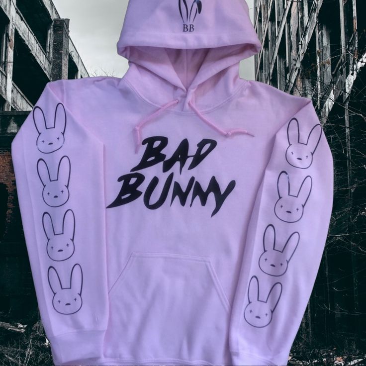 Brand New (Nwot) Bad Bunny Hoodie (Light Pink) With Bad Bunny On The Front, Bunny Ears On The Hood And Bunnies Down The Sleeves (Black). Pink Cotton Hoodie With Adjustable Hood, Casual Pink Hoodie With Ribbed Cuffs, Urban Pink Tops For Spring, Urban Style Pink Tops For Spring, Pink Adjustable Hood Sweatshirt For Spring, Pink Spring Sweatshirt With Adjustable Hood, Spring Pink Sweatshirt With Adjustable Hood, Urban Pink Cotton Sweatshirt, Pink Urban Hoodie With Letter Print