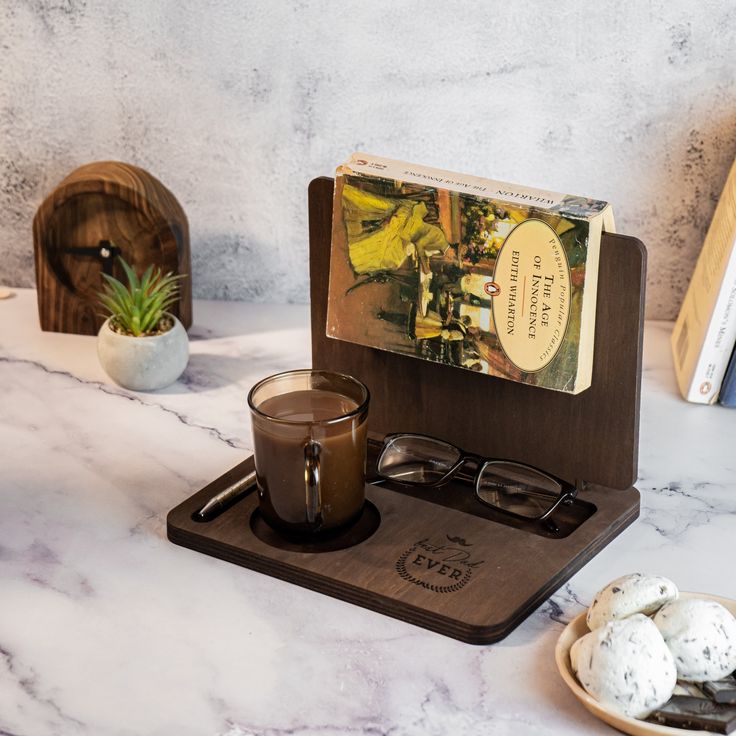 a cup of coffee sitting on top of a wooden tray