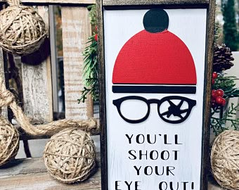 a sign that says you'll shoot your eye out with glasses on it next to some balls of twine