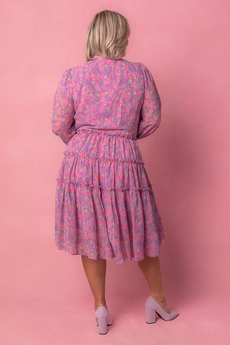 This Lydia Dress in Pink Floral is a versatile and functional choice for any occasion. With its vibrant purple base and delicate pink floral overlay, it is both stylish and practical. The v neckline and elastic cuffs add to the feminine appeal, while the lined, knee-length skirt features ruffle detailing for added flair. The functional buttons down the front make it nursing-friendly, so she's a perfect choice for new moms. Floral Overlay, City Woman, Nursing Friendly, Vibrant Purple, Knee Length Dresses, Knee Length Skirt, Dress Pink, Size 00, New Moms