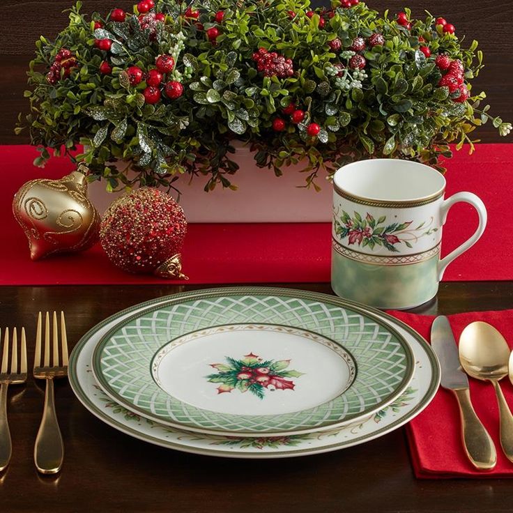 a table set with silverware and christmas decorations