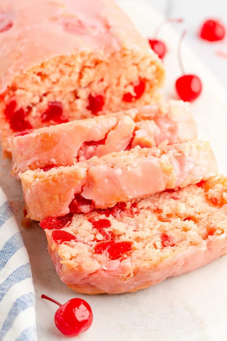 two slices of meatloaf with cherries on the top and one slice cut off