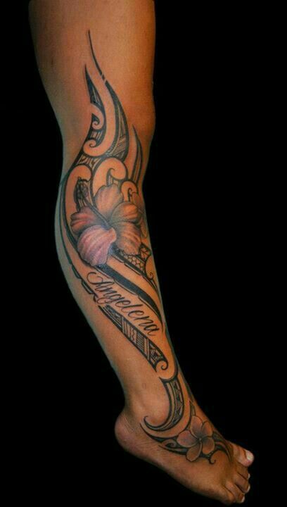 a woman's foot with a tattoo on it and flowers in the middle of her leg