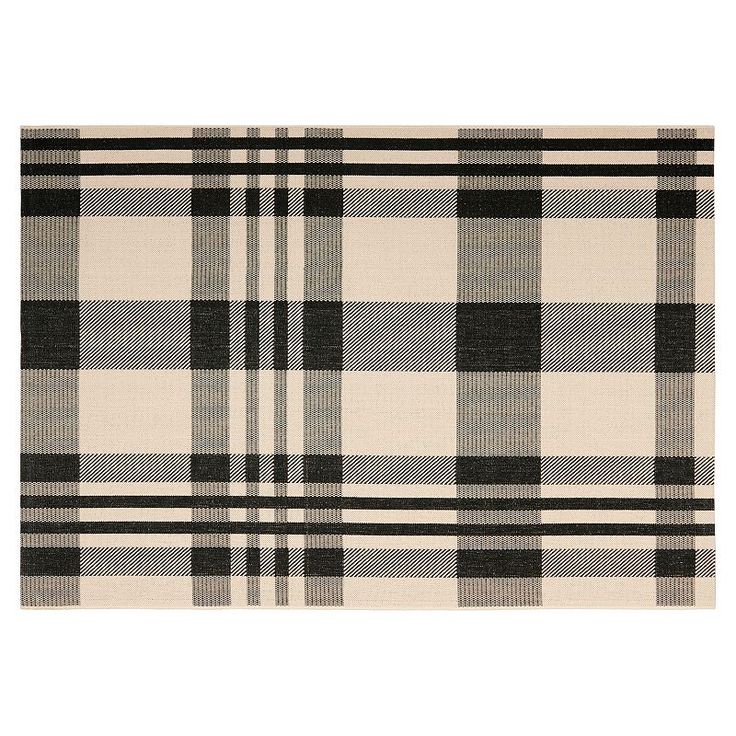 a gray and white plaid rug on a white background