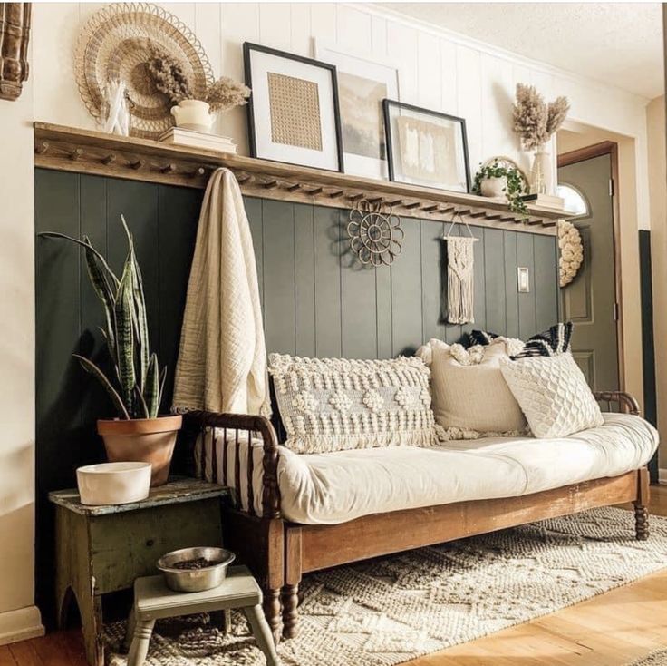 a living room filled with furniture and pictures on the wall