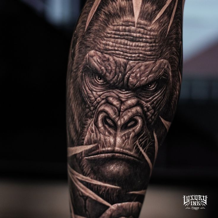 a man's arm with a gorilla tattoo on it