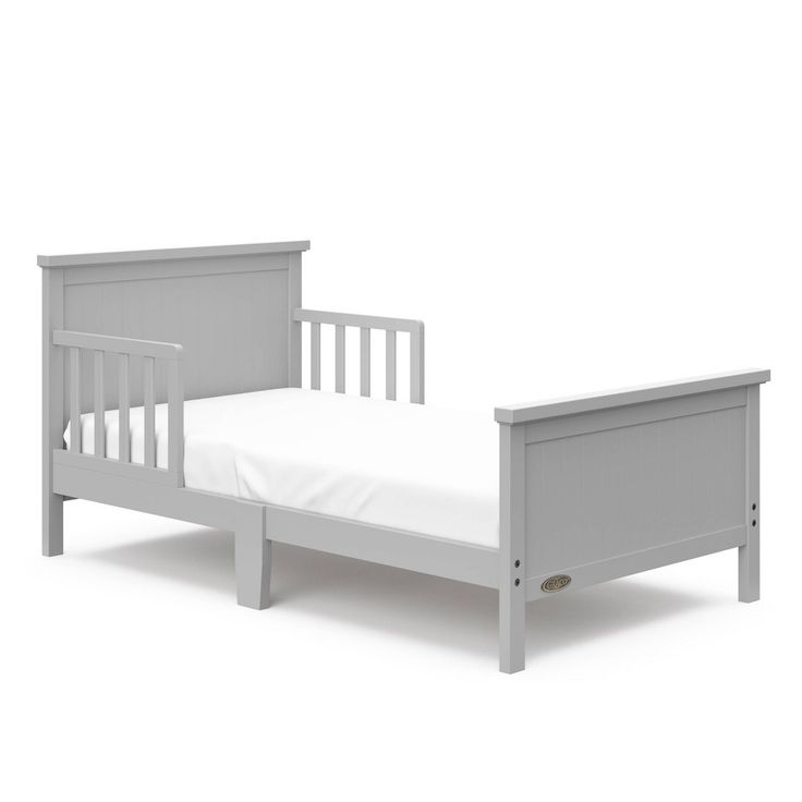 a white bed with a wooden frame and mattress on the bottom side, in front of a white background