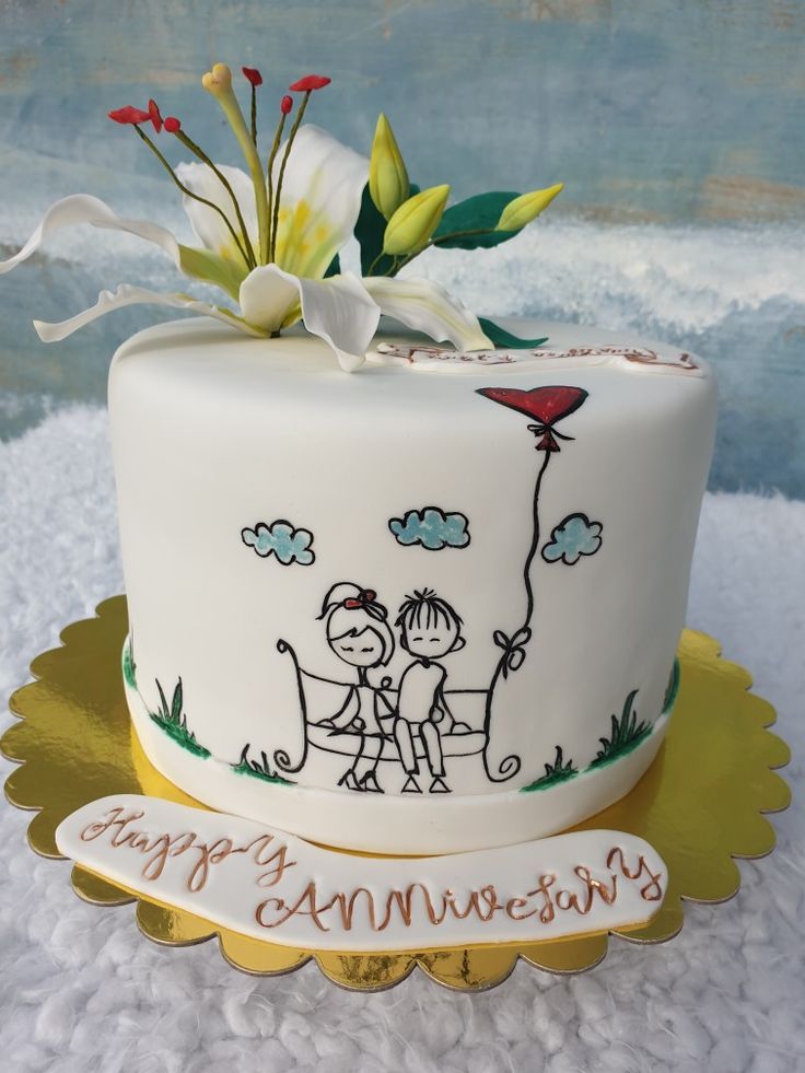 a white cake with an image of two people on it