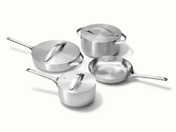 three pots and two pans on a white surface