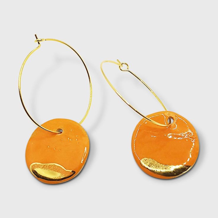 Orange and gold clay hoops earrings Iris. These clay earrings are simply gorgeous. The orange shade is wonderfull and the contrast with the real gold too. Orange is such a happy color and brighten your day and your outfit. For a stylish look, do not hesitate to gift yourself or someone you love these earrings. They come in a beautiful pink gift box. The style of the earrings is minimalist with geometric forms. Those earrings are very very light, few grams. All my earrings are handmade made by me in my studio. A layer of handpainted gold is applied with a brush. Here is an overview of my process, first the pendant is made using stoneware, which is a high temperature clay like porcelain, so it is solid. Once it is dry, I put the pendant in the kiln for 8 hours, then I glaze the pendant and p Orange Clay Earrings, Pink Gift Box, Orange And Gold, Vert Olive, Provence France, Hoops Earrings, Style Minimaliste, Pink Gifts, Happy Colors