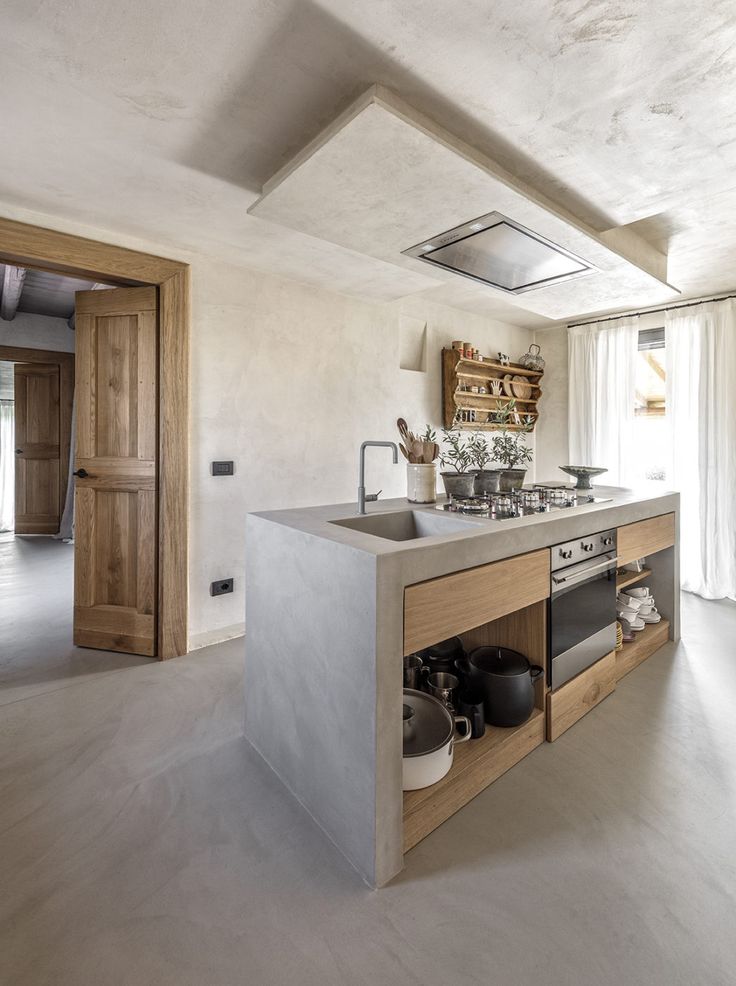 a kitchen with an island, stove and sink in the middle of it's room