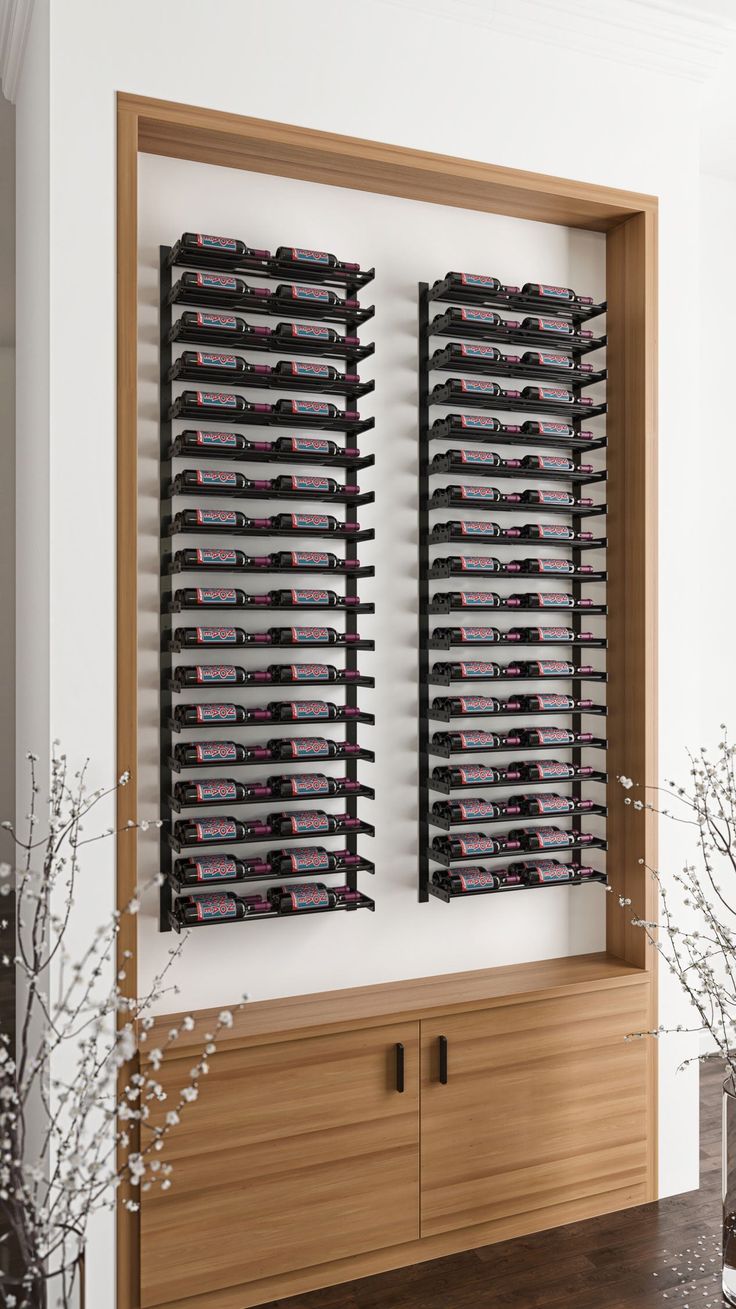 a wall mounted wine rack filled with lots of black and red glasses on top of a wooden cabinet