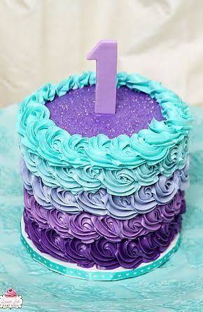 a purple and blue cake with the number one on it