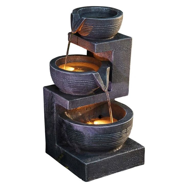 three bowls are stacked on top of each other with water pouring from them to the sides